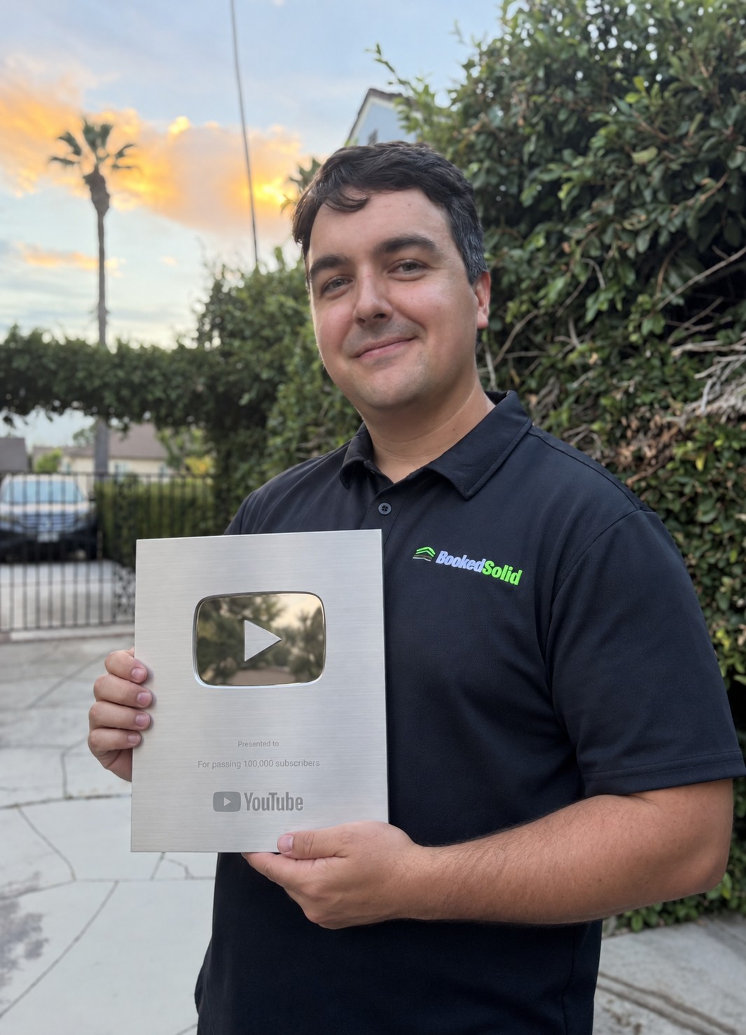 Ryan Kelly holding a silver YouTube award in an edited portrait